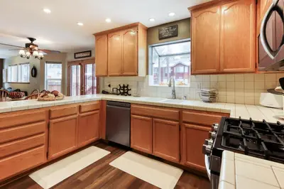 a kitchen with wooden cabinets and a stove at Gentian Family Retreat in South Lake Tahoe