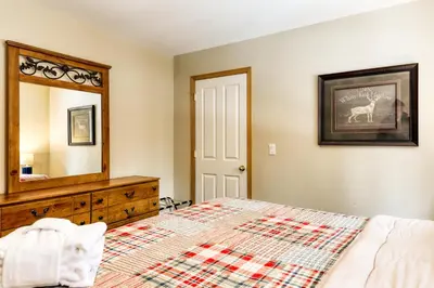 a bedroom with a bed and a dresser and a mirror at Gentian Family Retreat in South Lake Tahoe