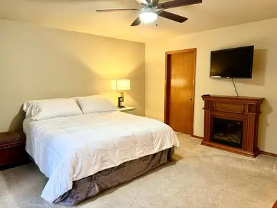 a bedroom with a bed and a flat screen tv at Meadow Landing in Three Rivers