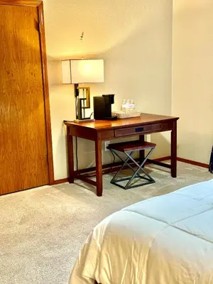 a desk in a hotel room with a bed at Meadow Landing in Three Rivers