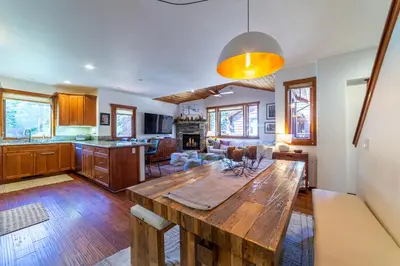 a kitchen and living room with a wooden table at Luxury home close to Village; Garage & Jacuzzi in Mammoth Lakes