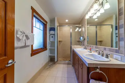 a bathroom with two sinks and a shower at Luxury home close to Village; Garage & Jacuzzi in Mammoth Lakes