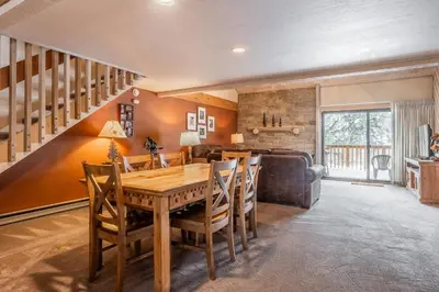 a dining room with a wooden table and chairs at Snowcreek #309 2 Plus Loft, 2 Bathroom Condo Sleeps 8 People with Amazing Mountain Views in Mammoth Lakes