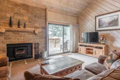 a living room with a fireplace and a tv at Snowcreek #309 2 Plus Loft, 2 Bathroom Condo Sleeps 8 People with Amazing Mountain Views in Mammoth Lakes