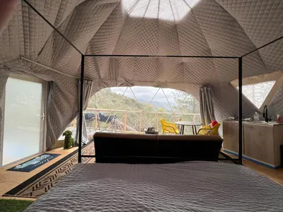 a bedroom with a bed in a tent at Mountain view Dome- 10 Minutes to National Park in Dunlap