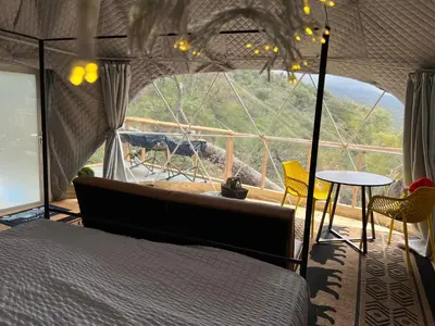 a bedroom with a bed and a view of a mountain at Mountain view Dome- 10 Minutes to National Park in Dunlap