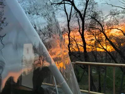 a reflection of a sunset in the windshield of a car at Glamping Dome 1 - 10 minutes from Kings Canyon in Dunlap