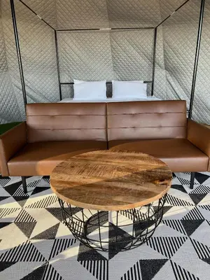 a couch with a table in a room at Glamping Dome 1 - 10 minutes from Kings Canyon in Dunlap