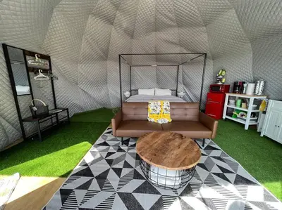 a room with a bed and a table in a tent at Glamping Dome 1 - 10 minutes from Kings Canyon in Dunlap
