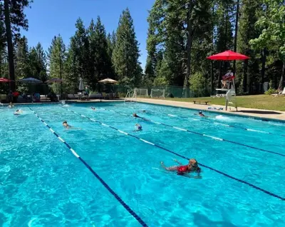 a group of people swimming in a swimming pool at Sweet Retreat: Theater, Pool/Ping-Pong, Quiet! in Camp Connell