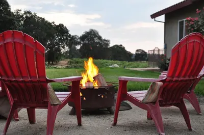 two red chairs sitting next to a fire pit at Master Suite Fraser Family Vineyard Stay in Amador in Plymouth