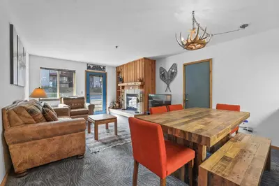 a living room with a wooden table and a couch at Cozy Kirkwood Condo – The Meadows 2 Bedroom condo in Kirkwood