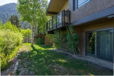 a house with a balcony on the side of it at Lakefront Mountain Retreat in June Lake