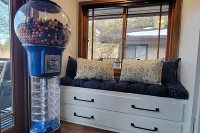a room with a bench with a glass ball machine at Lakefront Mountain Retreat in June Lake