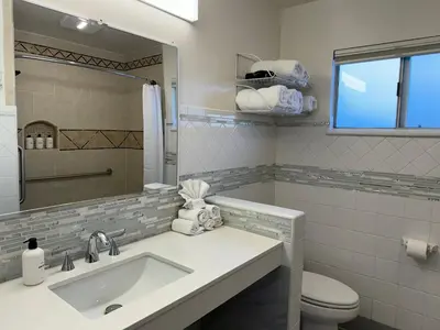 a bathroom with a sink and a toilet and a mirror at Eastern Sierra Motor Lodge in Independence