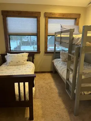 a room with two bunk beds and two windows at Cabin in the Woods in Tahoe Vista