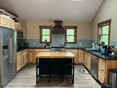 a large kitchen with wooden cabinets and a island in it at Cabin in the Woods in Tahoe Vista