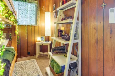 a room with wooden walls and white shelves at Enchanted Woodland Cabin Near Yosemite with Fire Pit in Groveland