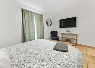 a bedroom with a bed and a flat screen tv at 4 Miles to Sequoia NTL Park in Three Rivers