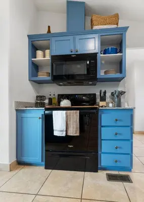 a kitchen with blue cabinets and a black oven at 4 Miles to Sequoia NTL Park in Three Rivers