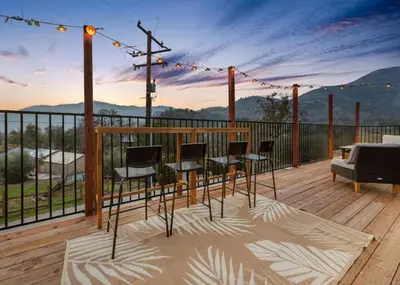 a deck with chairs and a table with a view at 4 Mil to Sequoia NTL Park Private River Access in Three Rivers