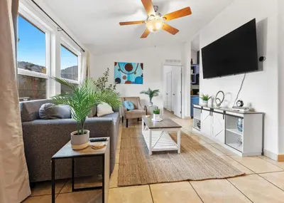 a living room with a couch and a flat screen tv at 4 Mil to Sequoia NTL Park Private River Access in Three Rivers