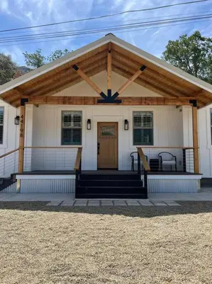 a small white house with a porch and a door at Soleil Luna 2 miles from Sequoia Park Entrance in Three Rivers