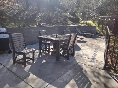 a wooden table and chairs on a patio at Yosemite Gatekeeper's Lodge in El Portal