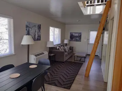 a living room with a table and a couch at Yosemite Gatekeeper's Lodge in El Portal