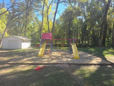 a playground with a slide in a park at Modern LakeHouse Sleeps 20 Hot Tub/Games/Fire Pit in Oakhurst