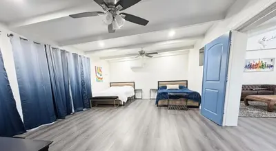 a bedroom with two beds and a ceiling fan at Modern LakeHouse Sleeps 20 Hot Tub/Games/Fire Pit in Oakhurst