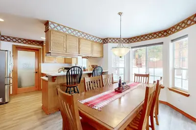 a kitchen and dining room with a wooden table at Blue Skies & Bay Bliss in Carnelian Bay