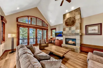 a living room with a couch and a fireplace at Sierra Shores Four - Lakefront Vistas in South Lake Tahoe