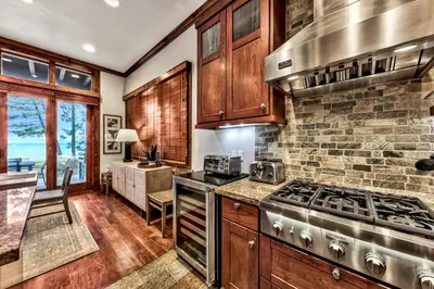 a kitchen with wooden cabinets and a stove top oven at Sierra Shores Five - Lakefront Comfort in South Lake Tahoe