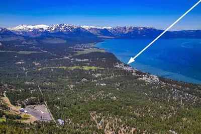 an aerial view of a lake and mountains at Sierra Shores Five - Lakefront Comfort in South Lake Tahoe