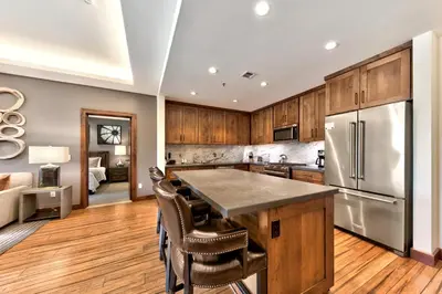 a kitchen with wooden cabinets and a stainless steel refrigerator at Zalanta 220 - Heavenly Wow-Pool View in Stateline