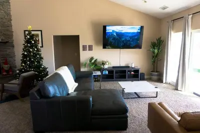 a living room with a christmas tree and a couch at Stargazing Retreat: fire pit/hot tub near Yosemite in Ahwahnee