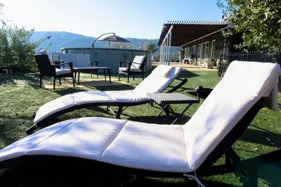 a group of white chairs sitting in the grass at Stargazing Retreat: fire pit/hot tub near Yosemite in Ahwahnee