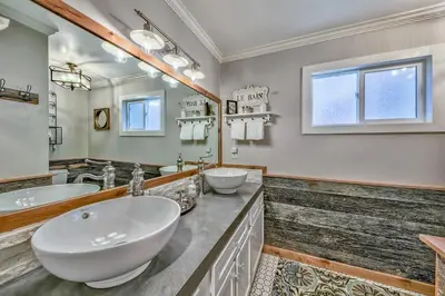 a bathroom with two sinks and a large mirror at Duckhook at Tahoe in South Lake Tahoe