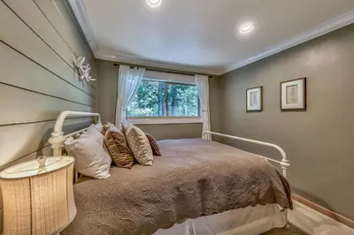 a bedroom with a bed and a window at Duckhook at Tahoe in South Lake Tahoe