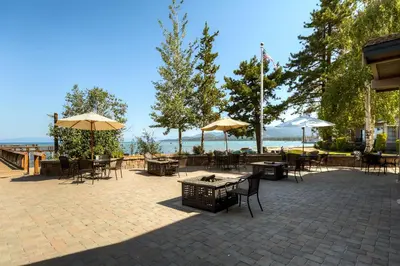a patio with tables and chairs and umbrellas at Lakeland Village 406 - The Lake Escape in South Lake Tahoe