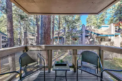 a balcony with two chairs and a table at Lakeland Village 406 - The Lake Escape in South Lake Tahoe