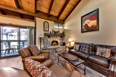 a living room with leather furniture and a fireplace at Lakeland Village 471 - Resort Magic 2BR Loft in South Lake Tahoe