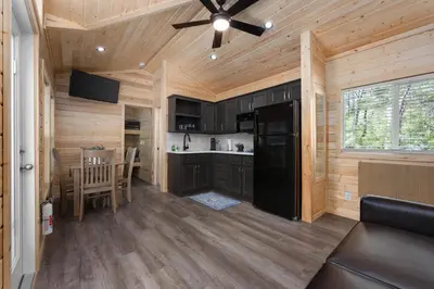 a kitchen and dining room of a log cabin at Brand new Cabins in Kernville