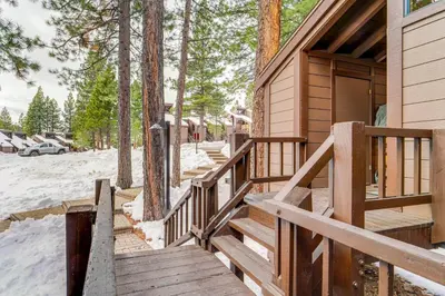 a wooden stairway leading to a cabin in the snow at Northstar Resort Condo with Hot Tub, Shuttle Access! in Truckee