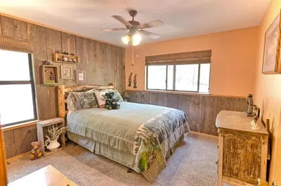 a bedroom with a bed and a ceiling fan at *Pinecone Hollow*Hot Tub & Game Room, Families in Arnold