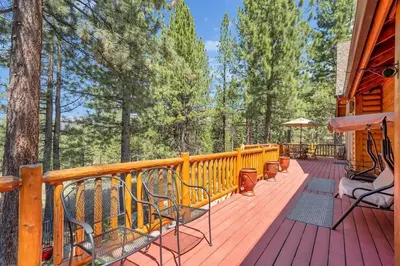 a wooden deck with chairs on a house at 1603 Bel Aire Circle home in South Lake Tahoe