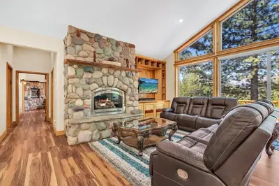 a living room with a large stone fireplace at 1603 Bel Aire Circle home in South Lake Tahoe