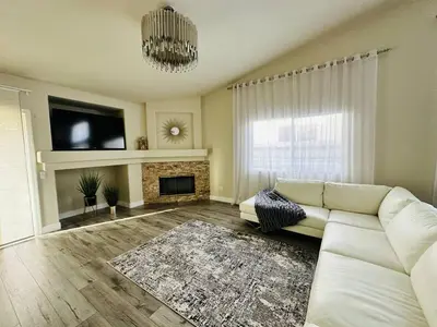 a living room with a white couch and a fireplace at Sweet Holiday in Antelope