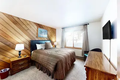 a bedroom with a large bed and a window at Snowcreek 264 in Mammoth Lakes